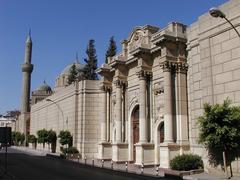 parts of a large golden gate tower decorated with intricate designs from an old mosque in Cairo, Egypt