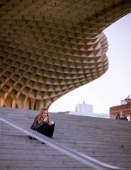 woman eating an ice cream under a parasol