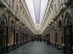 Galerie in Brussels with people walking under an arched glass roof