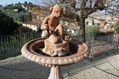 Old fountain with boy statue in Giardino delle Rose