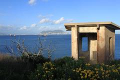 Guardia Civil watchtower near Getares cove in Algeciras, Spain, with Algeciras Bay and the Rock of Gibraltar in the background