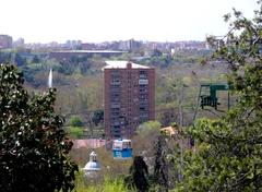 Apartment building in San Pol de Mar Street, Madrid with cable car gondola and dome of San Antonio de la Florida Hermitage in foreground