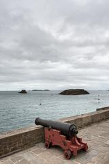 Cannon on city walls in Saint-Malo, France with Grand Bé and Petit Bé islands in the background