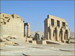 Osiride pillars in the second courtyard of the Ramesseum with the colossal head of Ramses II and entrance to the hypostyle hall