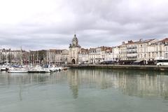 bassin d'échouage du Port de La Rochelle with boats and Grosse Horloge on a gray day