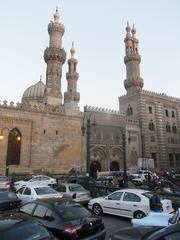 Busy Cairo street with various vehicles and people