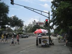 Decatur Street view with Jackson Square and Jax Brewery Building in New Orleans French Quarter, with ice cream vendor cart visible