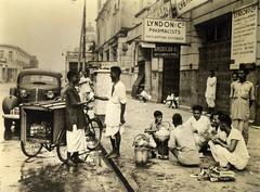 Natives having breakfast on a sidewalk in Calcutta, 1945