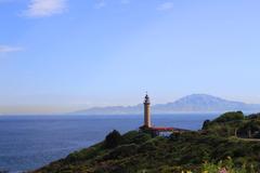 Faro de Punta Carnero in Algeciras, Spain with Mount Musa in the background