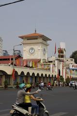 inside view of Ben Thanh Market with stalls of exotic fruits and handicrafts