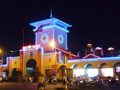 Southern gate of Ben Thanh market at night in colourful lights