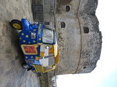 Tourist motorcar in front of Castello d'Otranto, west tower, Piazza Castello