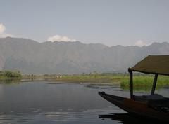 silhouette of a shikhara on Dal Lake with scenic hills in the background