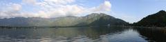 Scenic view of Dal Lake in Srinagar with Shikara boats and mountains in the background