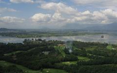 Scenic view of Dal Lake with Shikara boats and mountains in the background