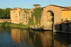 Lungarno in Pisa with riverside buildings and blue sky