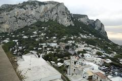 Street view of Capri town with Monte Solaro in the background and road to Anacapri carved in the cliff