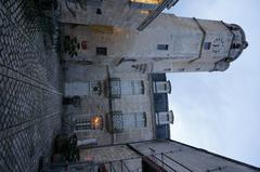 Musée courtyard with stone buildings and trees