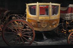 Horse-drawn carriages displayed in a grand hall