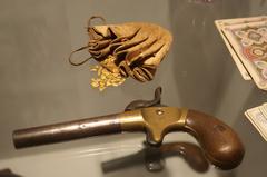 19th century leather purse with fluvial gold nuggets, single shot pistol, and playing cards