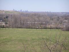 Wide-angle view of Cahokia Mounds featuring mounds, grassy landscape, and blue sky