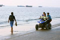 Couple riding beach motorbike at Patenga Sea Beach