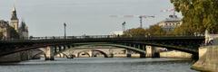 four bridges on the Seine River with boats and buildings in the background