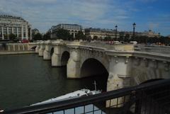 Le pont Neuf bridge over the Seine River with people and boats