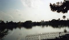 Tripura Palace Compound with an old building and lush greenery