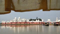 Wide view of Neermahal palace surrounded by a lake