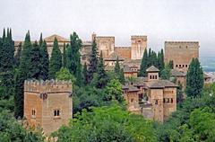 Scenic view of a historic Spanish hilltop town with stone buildings and a bell tower