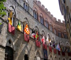 Palazzo Chigi-Saracini in Siena with contrade flags