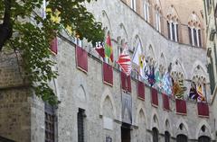 Colorful Palio di Siena flags displayed in Siena, Italy