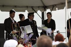 Family members accepting the Sirius Courage Award for SGT Zainah Creamer, with her surviving dog Jofa.