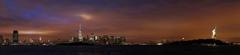 Panoramic night view of Manhattan, Brooklyn, New Jersey, and Statue of Liberty during a storm