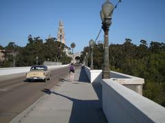 Scenic view of an old bridge, park, and car in a classic setting