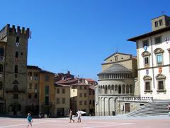 Piazza Grande in Arezzo with historical buildings and blue sky