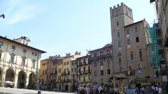 Panoramic view of Arezzo cityscape with historical buildings and lush greenery