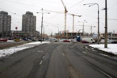 View of Skłodowskiej-Curie Street with a shopping mall under construction in the background