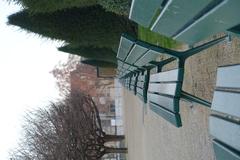 Green public garden benches in Square de l'Île-de-France, Paris, France