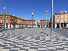 Facades of Place Masséna in varying shades of Sardinian red