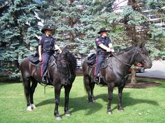 Two Calgary Police officers on horseback at Olympic Plaza park in downtown Calgary