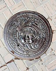 Drain cover at Olympic Plaza in Calgary with Olympic bricks