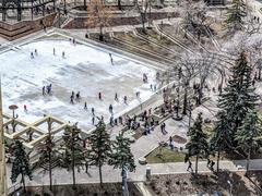 Melted ice rink at Calgary's Olympic Plaza with children playing