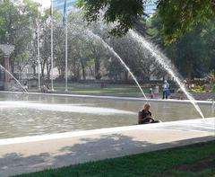 people cooling off in an Olympic Plaza water feature during a heat wave in 2018