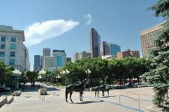 bronze horse sculptures in front of Calgary skyline