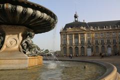 a picturesque view of Bordeaux with historic architecture and bridges over the Garonne River