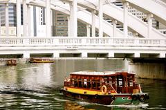 Bumboat passing under Elgin Bridge, Singapore