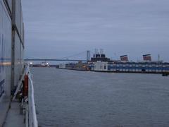 view from a ship featuring calm waters, cloudy sky, and distant horizon