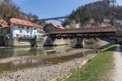 Bern Bridge over the Saane River and Angel Inn in Fribourg, Switzerland with Galtera Bridge in the background